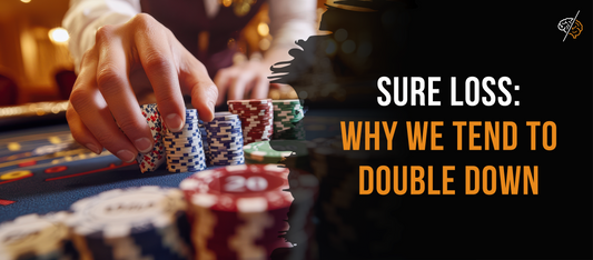A hand places poker chips on a casino table, illustrating the psychology of risk, loss aversion, and the tendency to double down after losses.